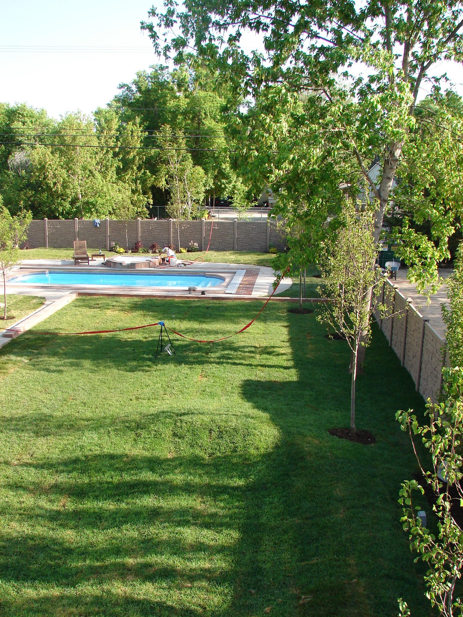 Backyard after renovation with a new swimming pool and lawn