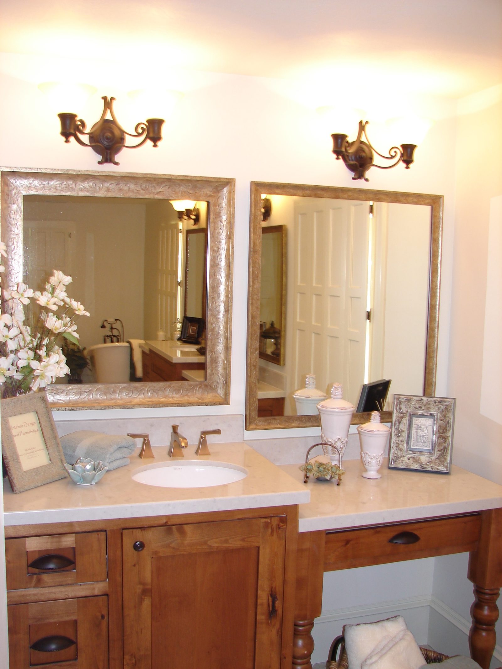 Bathroom vanity with twin mirrors and wall sconces