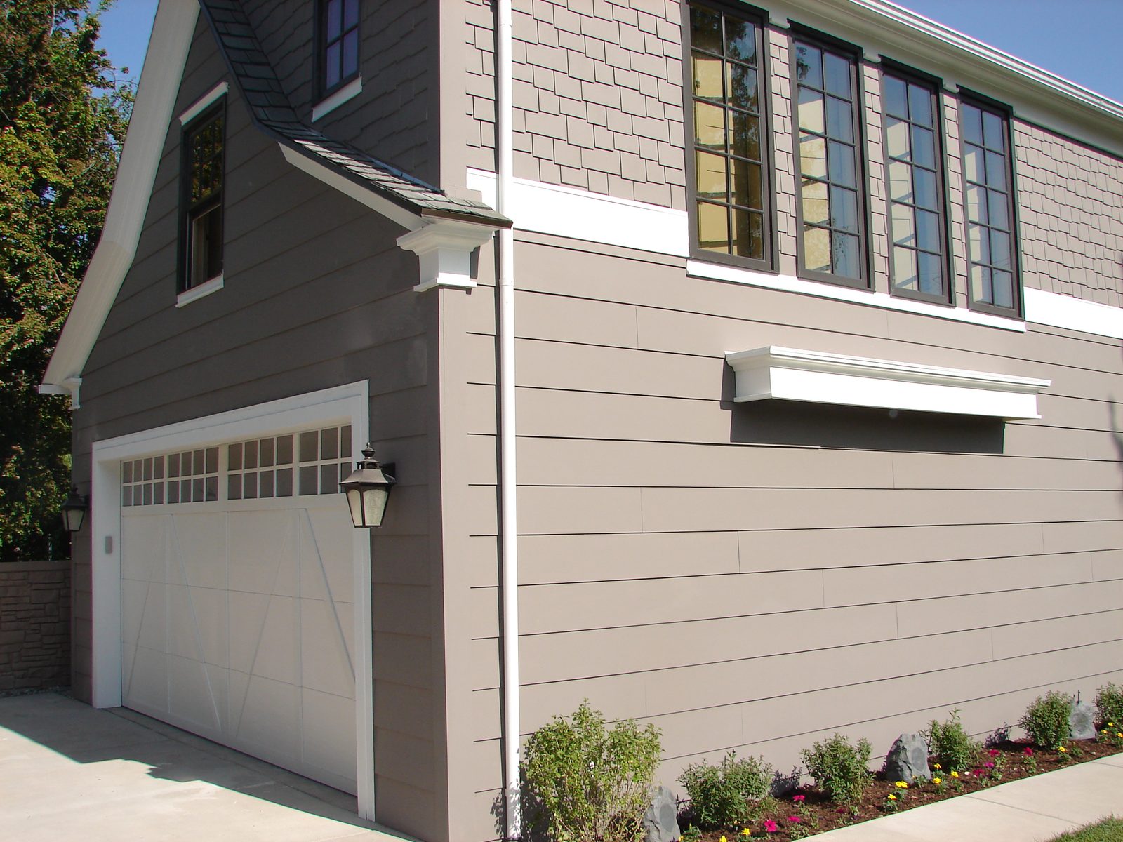 Detached garage after renovation, resided and refinished with a new door