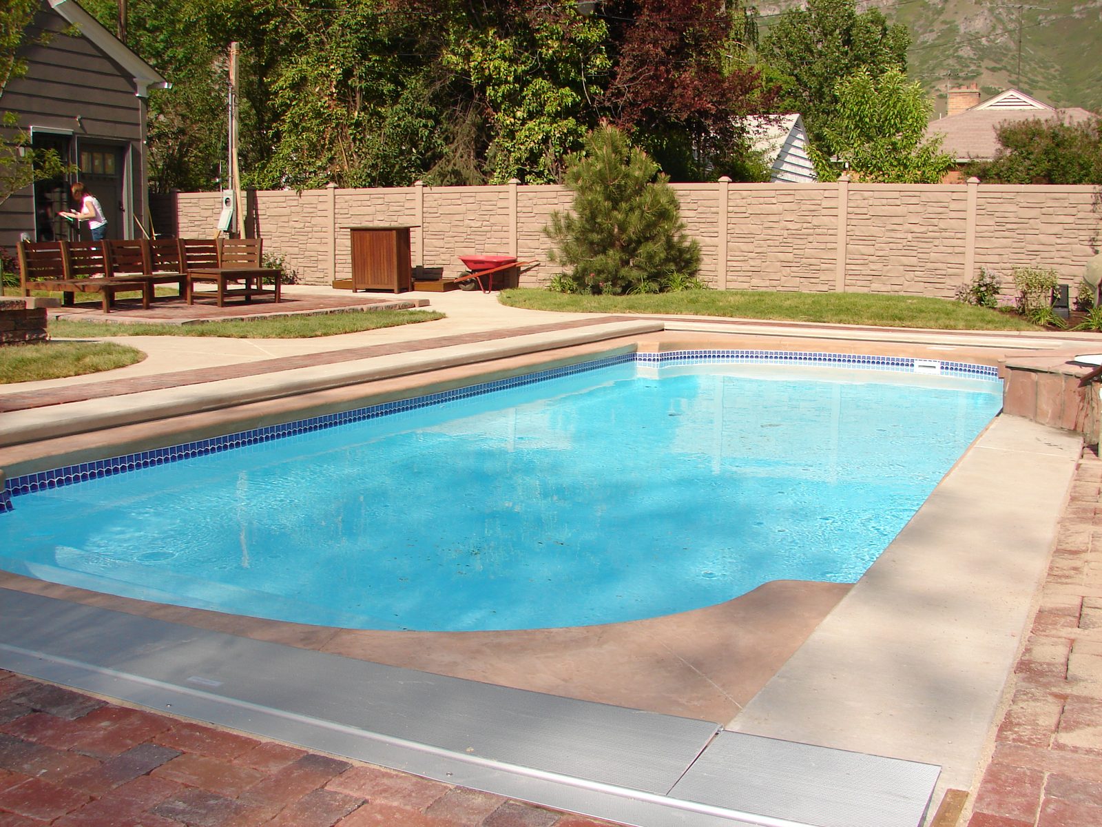 Swimming pool with a concrete and brick surround