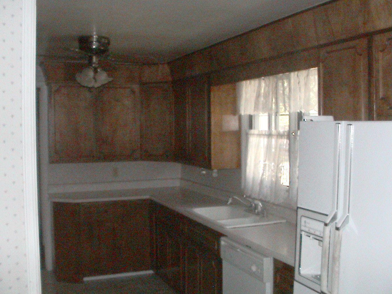 Corner of the same dated kitchen before the remodel