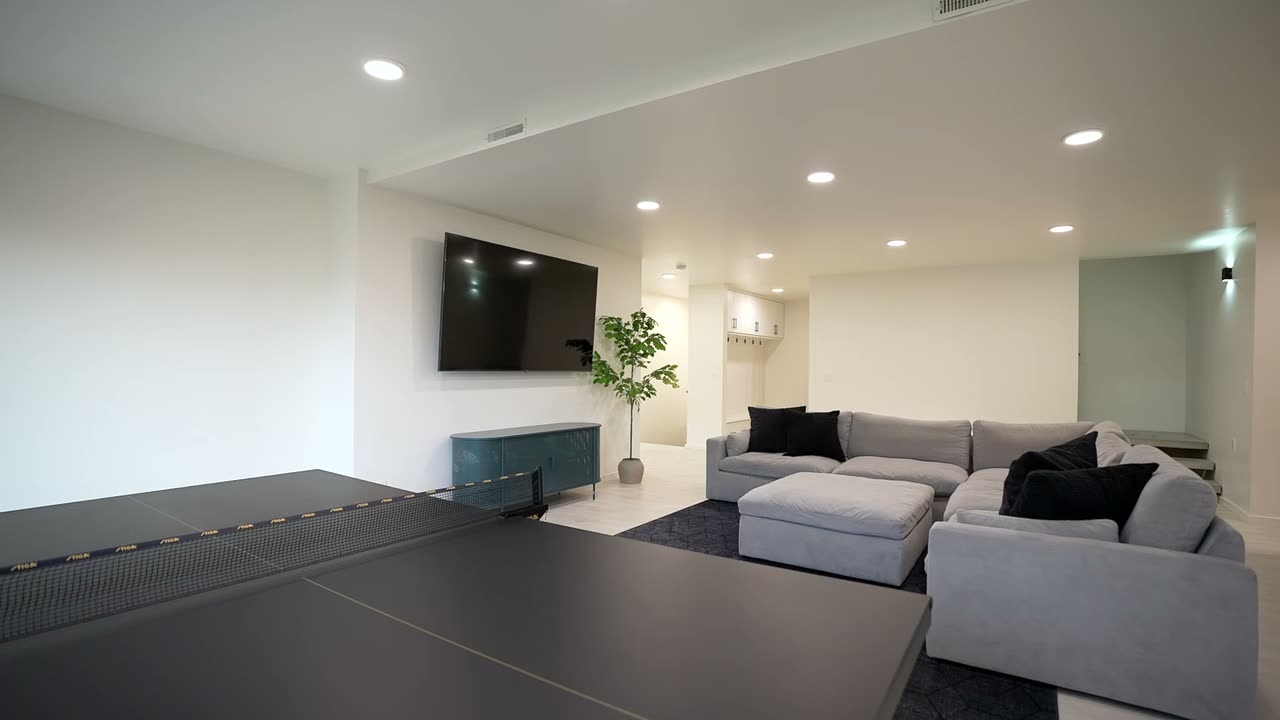 Finished lower level lounge with built-in seating and a bar