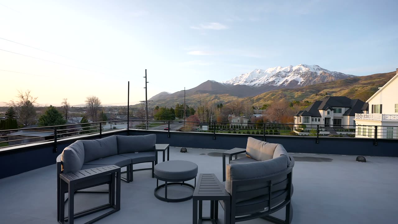 Rooftop deck with lounge seating looking toward the mountains
