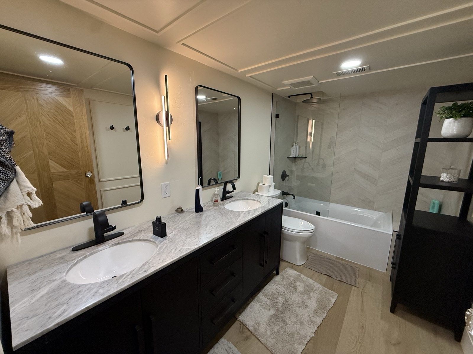 A remodeled bathroom with a marble vanity