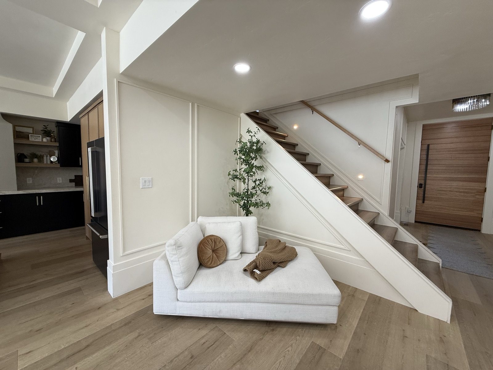 A white oak floating staircase with a glass rail
