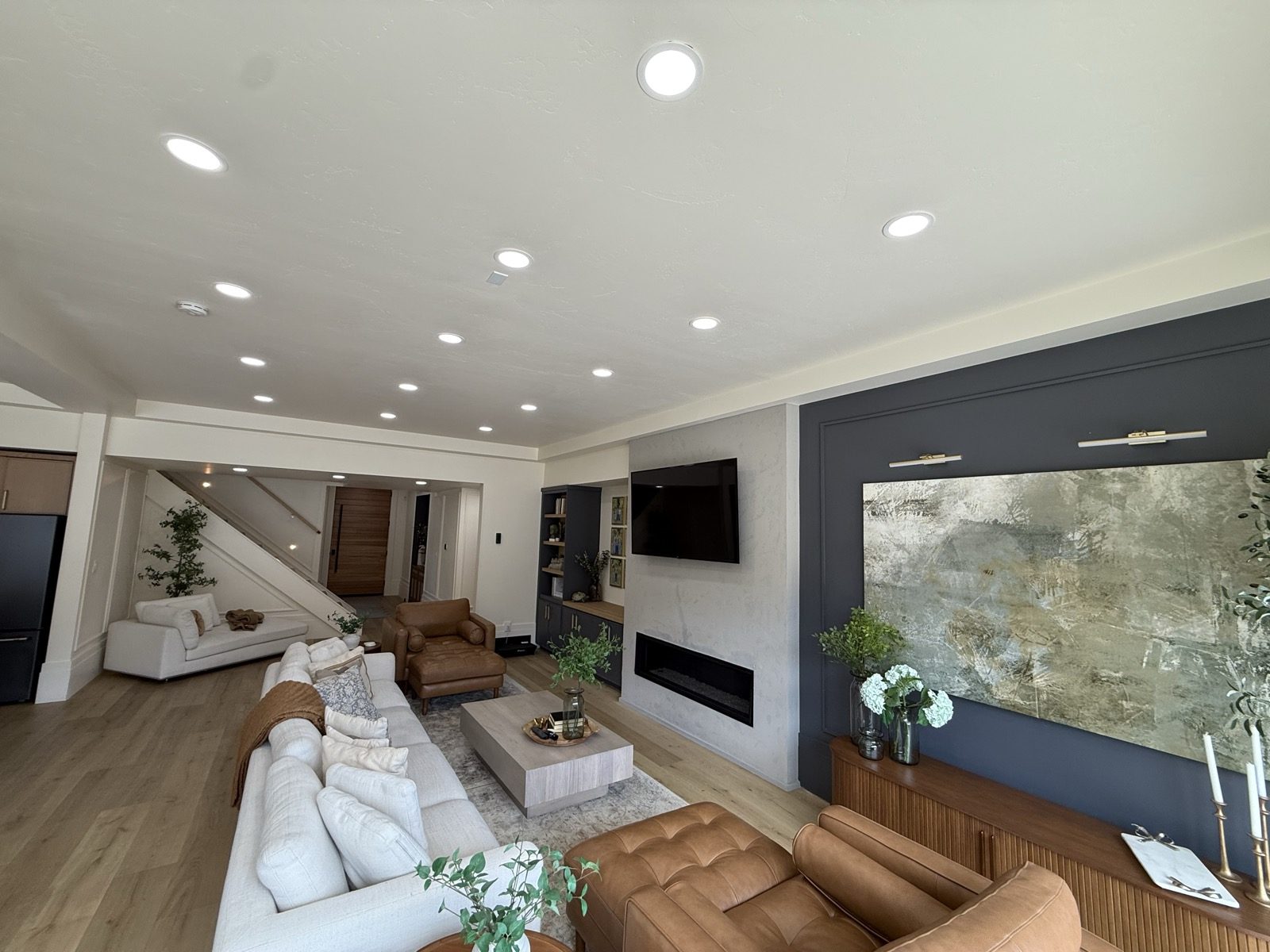 The living room with a linear fireplace and built ins