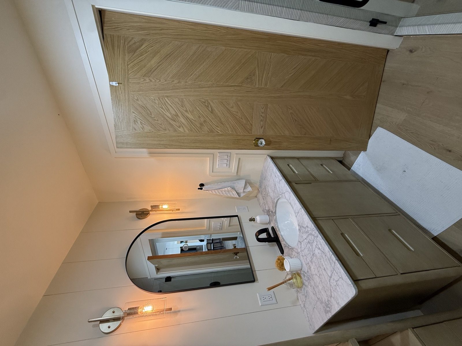 A primary bath after, with a freestanding tub and a chevron wood ceiling