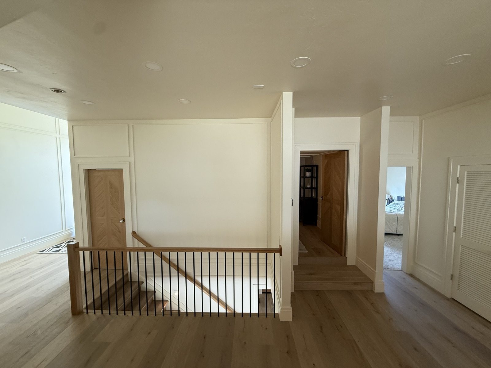 The upper landing and hallway with a wood railing