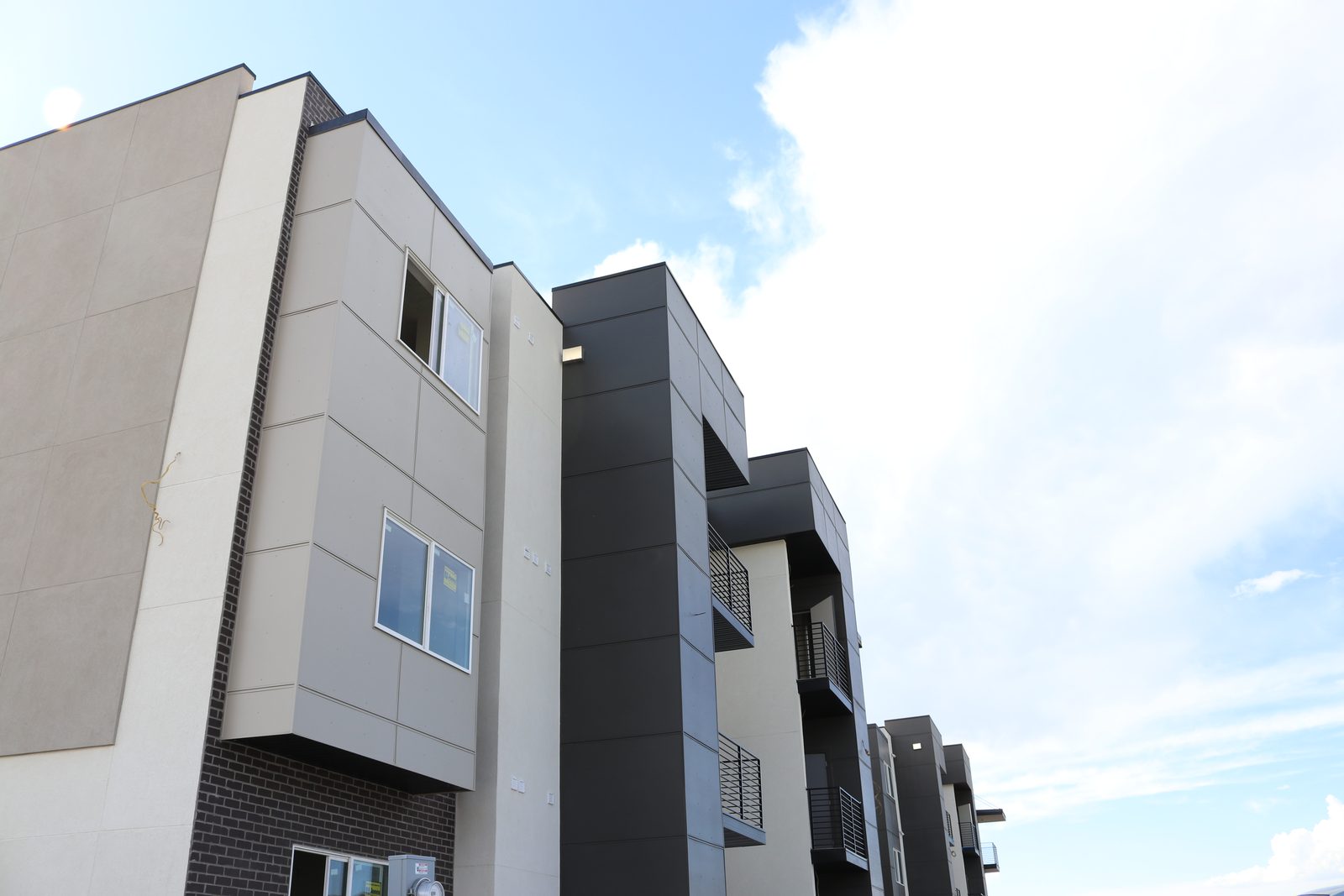 Angled view of a modern apartment building at The Vine with balconies and mixed cladding